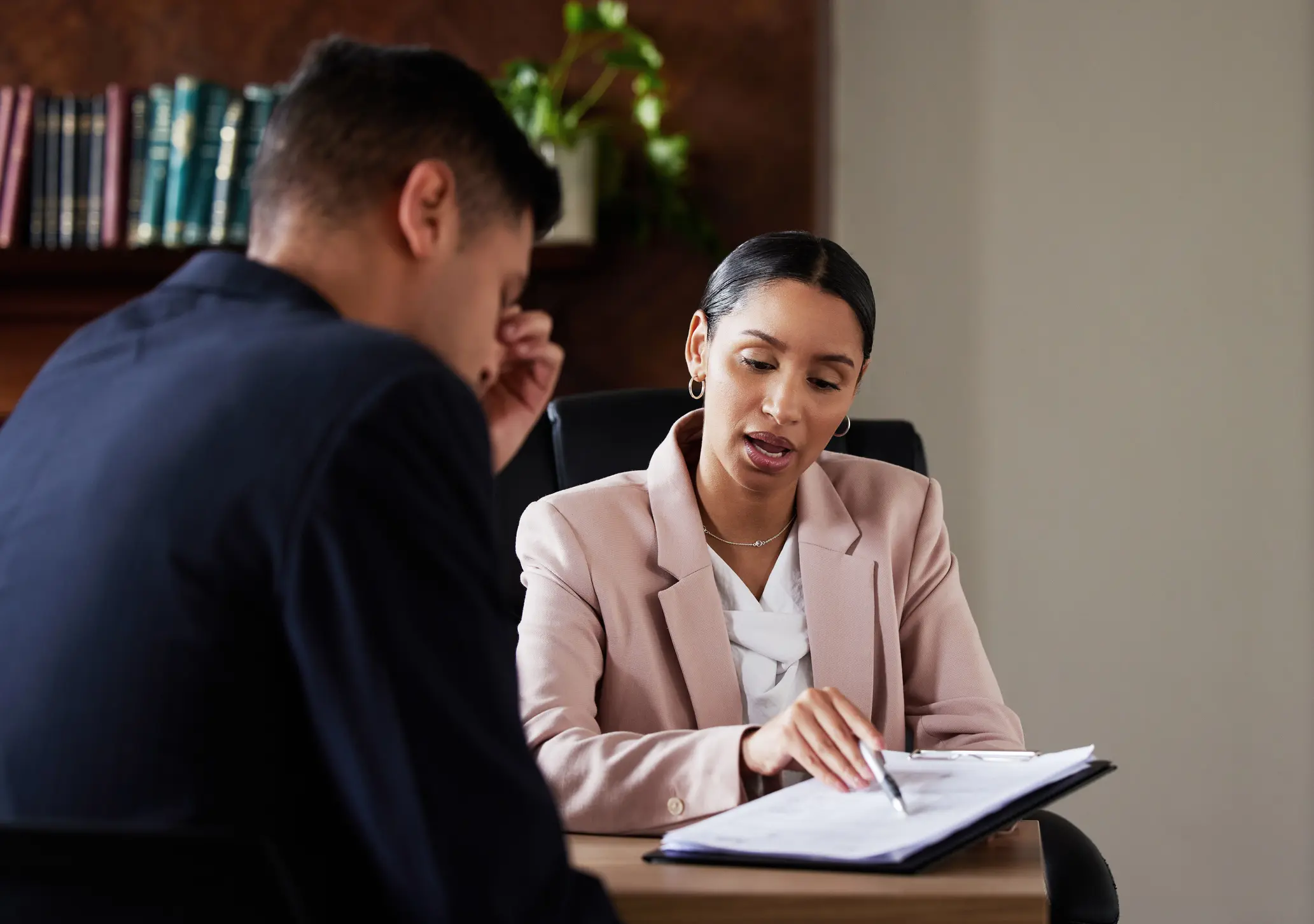 Legal, lawyer and man with contract, consultation or signing for business, explain or conversation in workplace. Female employee, male client or services for advice, consulting or documents in office
